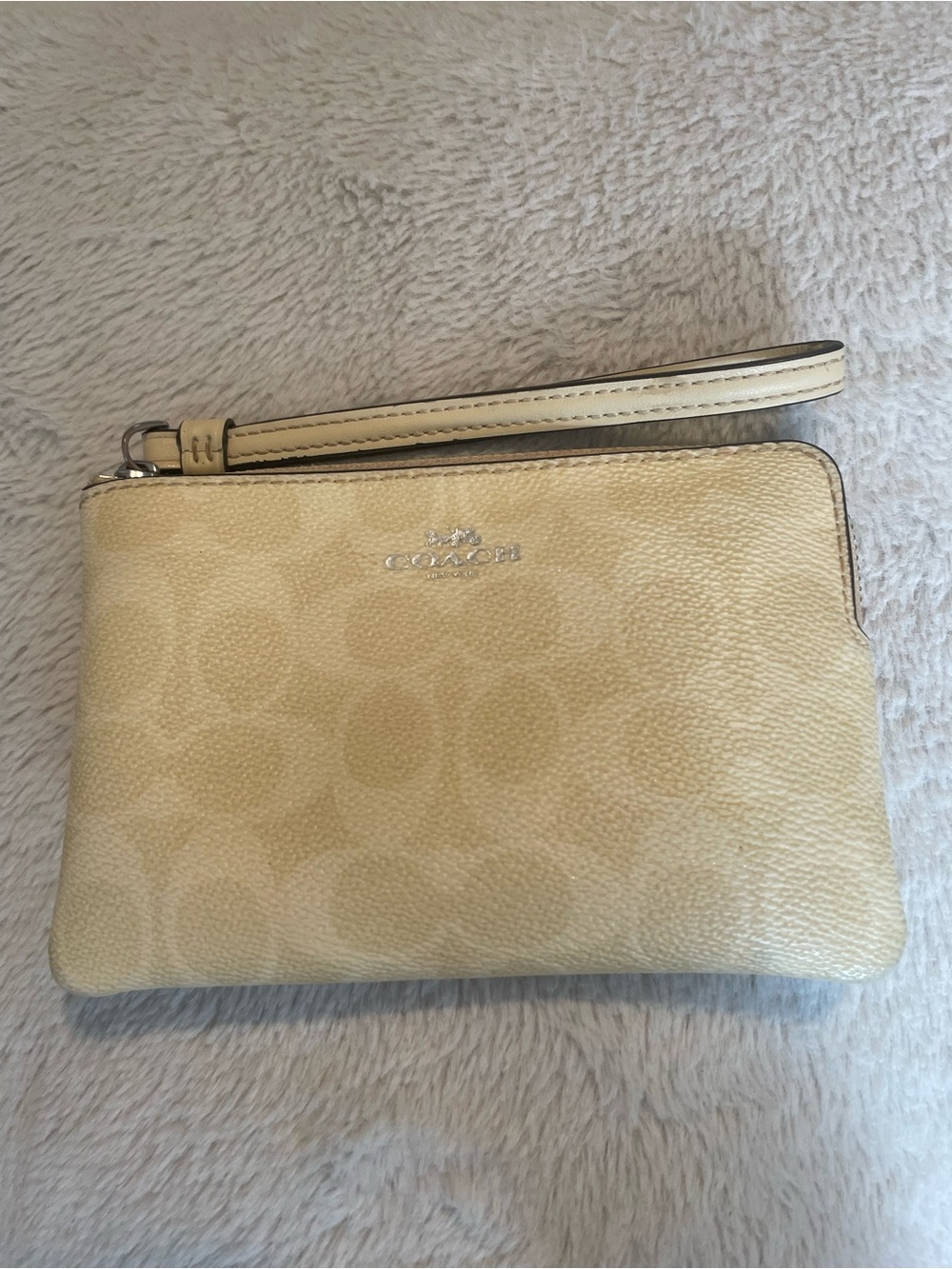 Coach Signature Wristlet in the color Hay